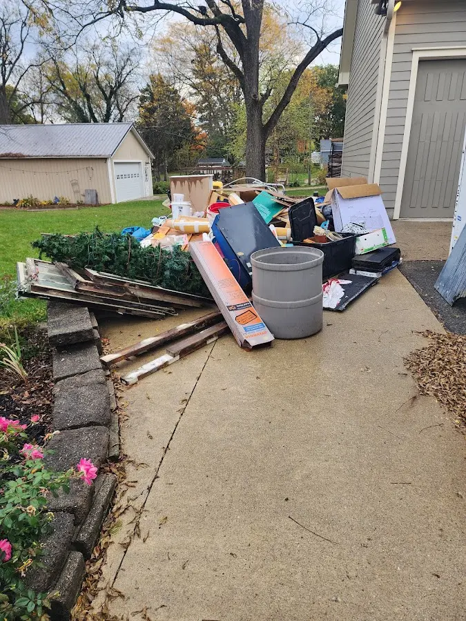 Dumpster being loaded with debris for Estate Cleanout Dumpster Rental in Brookmont